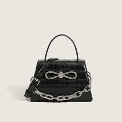 Bolso con asa y cadena con lazo de cristal y estampado animal - Negro